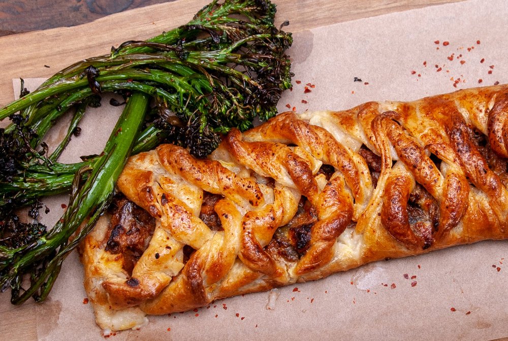 Baked garlic bread twisted with cheese and topped with herbs